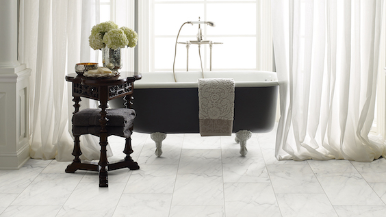 elegant tile flooring in a white bathroom with a tub and white curtains