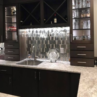 countertop installation in a Columbia MO kitchen with black cabinets and tile backsplash