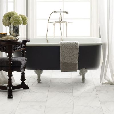 white tile floors in a elegant bright bathroom with freestanding tub